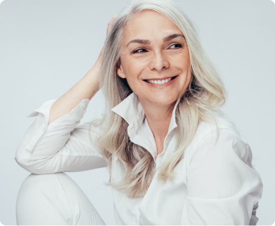 A smiling woman with grey hair
